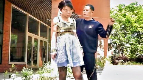 Chinese girl leashed and bound in outdoor BDSM training
