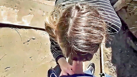 Blonde woman in stripes giving POV blowjob by the lake outdoors