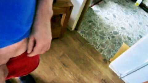 Hairy bear pulling down red underwear exposing erect cock for handjob