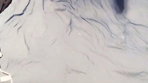 Close-up of wrinkled white bedsheets after amateur sissy cumshot solo play