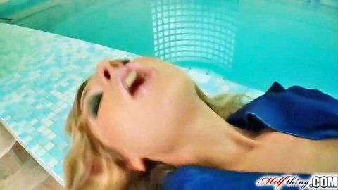 Blonde MILF with mouth wide open in ecstasy lounging poolside