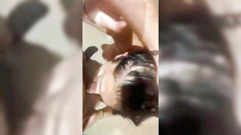 Blurry POV close-up of dark-haired woman giving intense eye contact during oral on flaccid cock
