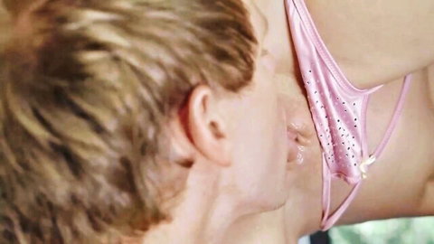 Blonde man licks wet shaved pussy with pink lace thong pulled aside closeup