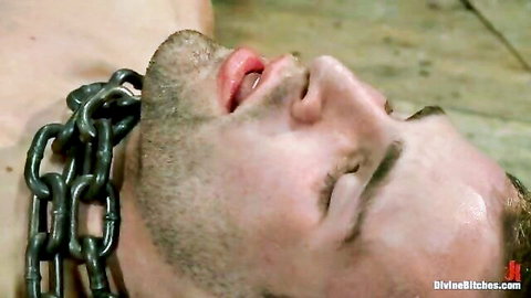 Submissive Blake chained and dominated by Isis Love in BDSM pegging scene
