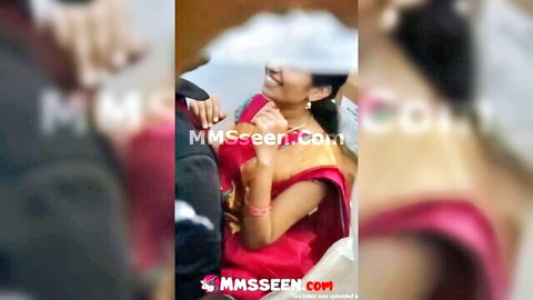 Kannada Indian aunty in red saree smiling with man in intimate pose