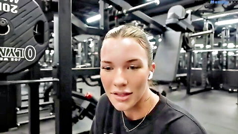 Blonde athletic woman in gym tank top during quad workout