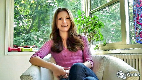 Kate smiling seductively in pink sweater, solo amateur vibe