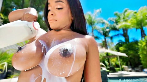 Lily Starfire pours milk on her huge natural ebony breasts outdoors