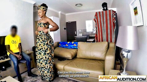 Curvy African woman in floral dress catwalks during audition