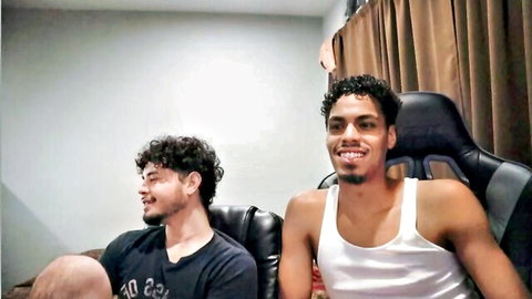 Two curly-haired Latino guys smiling in casual amateur gay thumbnail