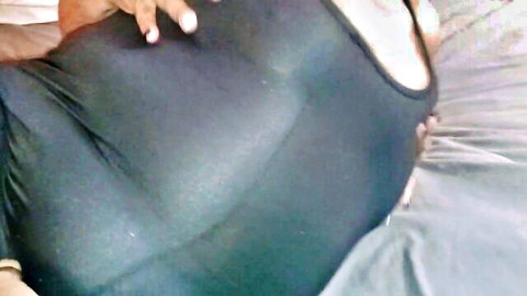 Mature granny with large butt in tight black bodysuit, teasing hand pose