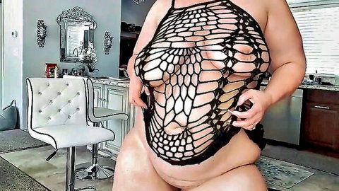 Ursula hot BBW flaunting curves in revealing fishnet top