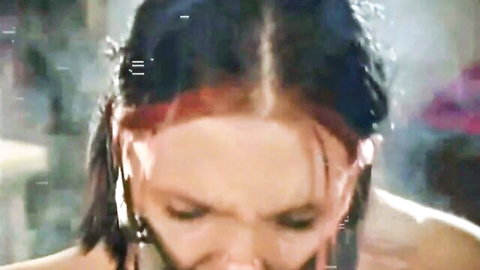 Close-up of wet-haired woman with intense expression in ashtray slave fetish scene