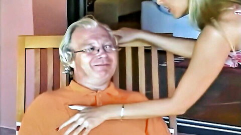 Blonde MILF naughtily gropes old man's chest outdoors on porch