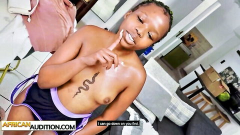 Young black African coed topless in casting audition, snake tattoo on chest