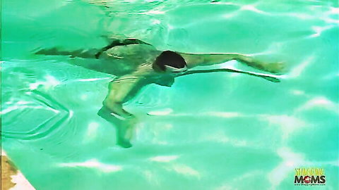 Underwater pool scene with mature blonde in adult video penetration
