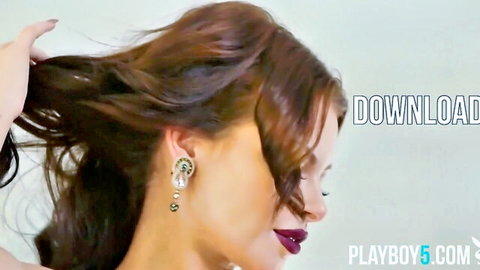 Sensual brunette babe tossing long wavy hair in profile with plump red lips and pearl earrings