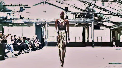 Ebony model struts braless in revealing beaded skirt on fashion runway