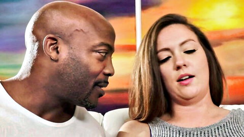 Bald black man and curvy white woman in close intimate pose