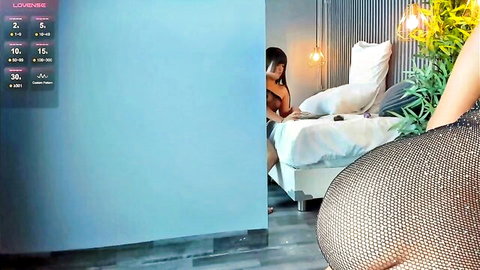 Flirtatious Asian girl in sparkly dress teasing solo on bed