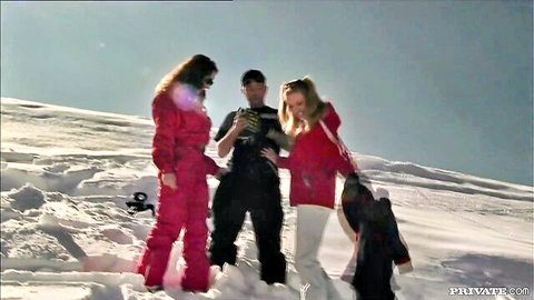 Naughty blonde and brunette ski babes in tight red suits teasing guy on snowy mountain threesome
