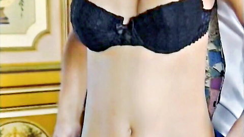 Busty blonde in black lace bra, deep cleavage, vintage 1998 adult scene