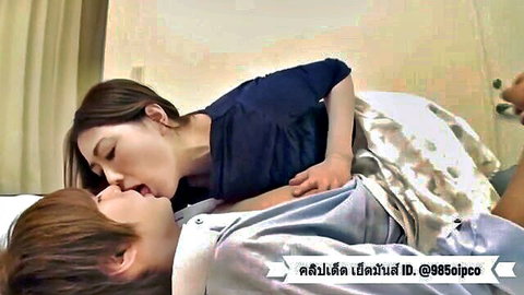 Beautiful Asian woman passionately kissing man in intimate embrace