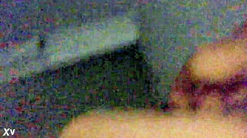 Blurry dark-haired woman in dimly lit room, adult video thumbnail