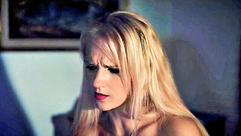 Suzie Q blonde in tense, dimly lit terror scene, worried expression