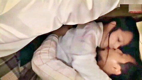 Cute Asian girl intimately embraces friend's dad under bed covers