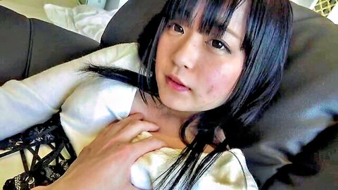 Seductive Asian girl in white lace top teasing cleavage
