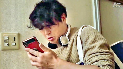 Young Asian twink in sweater surprised by sex request on phone