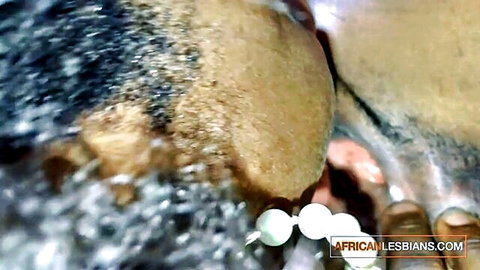 Close-up of South African black lesbian couple scissoring intimately
