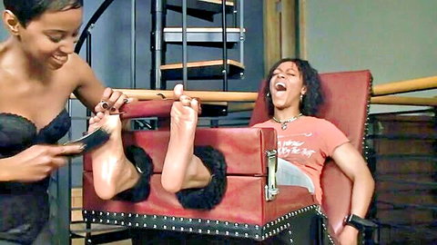 Ebony woman in lingerie tickles bound girl's bare feet, laughing in tickle torment