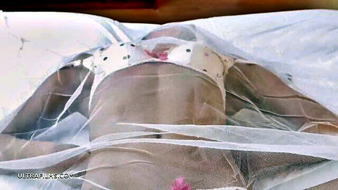 Lily Chey in ultra hot polka dot lingerie under mosquito net
