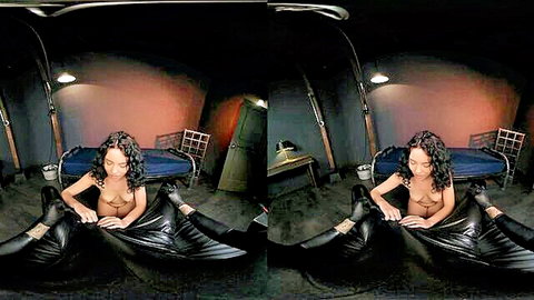 Ebony woman topless in black leather pants, hands covering, teasing pose