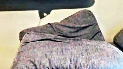 Close-up of wrinkled gray fabric cushion on chair seat