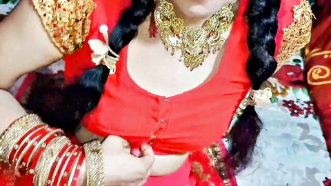 Busty Indian babe in red saree blouse teasing deep cleavage with gold necklace and bangles