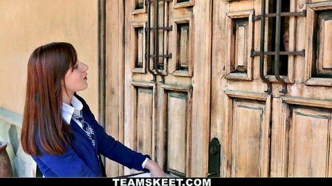 Young redhead schoolgirl in tight uniform teasing at barred prison door