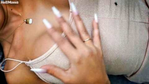 Busty MILF squeezes huge tits in sparkly top showing deep cleavage with long white nails