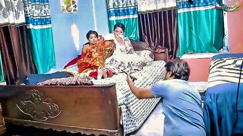 Indian groom discovering wife and daughter-in-law in sarees on bed