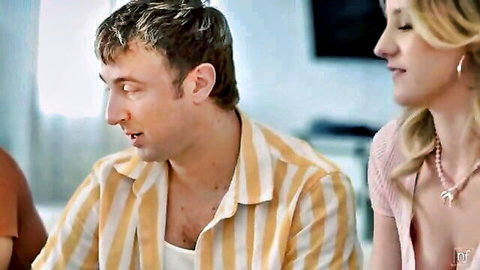 Blonde woman in low-cut top teases man with cleavage in casual chat