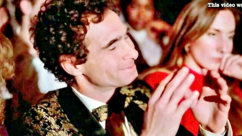 Vintage 1982 couple in elegant attire clapping at adult show