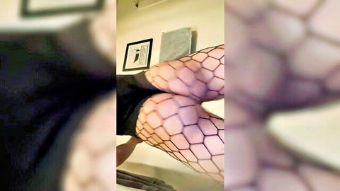Feminine dude teasing with bouncy ass in fishnet stockings