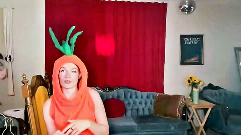Ginger babe in sexy carrot costume showing deep cleavage on webcam couch