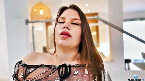 Seductive brunette in sheer black lingerie top, teasing expression, Nubiles solo fun