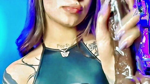Tattooed beauty deepthroating toy with glossy lips in halter top