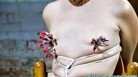 Diamondly bound in rope with red nipple clamps, BDSM torment