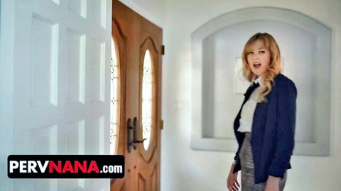 Blonde MILF cougar in blazer and skirt smiling seductively in elegant hallway doorway