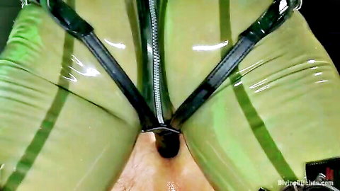 Blonde Mistress Tatjana in green latex harness dominates handsome slave